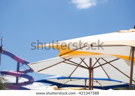 Beach umbrellas and blue sky background.
