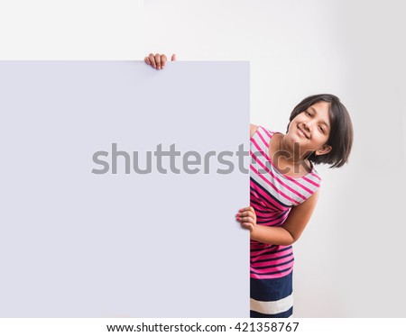 Cute little Indian girl presenting empty white board