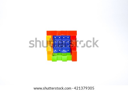 Colorful toy plastic block or puzzle isolated on white background. Selective focus.