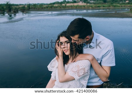 Couple in love embracing near lake