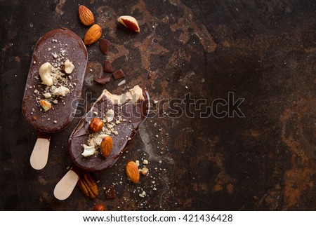 Classic chocolate ice cream with nuts on old background, selective focus