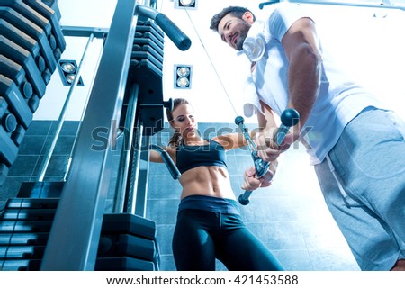 A young couple training together in the Gym.