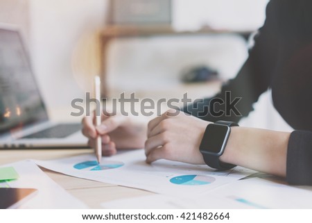 Photo Woman Working Modern Office.Girl Wearing Generic Design Smart Watch.Female Hands Writing notes. Account Manager Work Process at Wood Table.Horizontal mockup.Burred Background. Film effect.