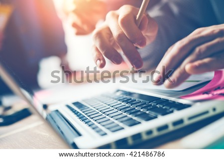 Typing on laptop close-up. Meeting report in progress. Film effect, blurry background Royalty-Free Stock Photo #421486786