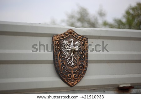 Heraldic shield with eagle on the metal fence