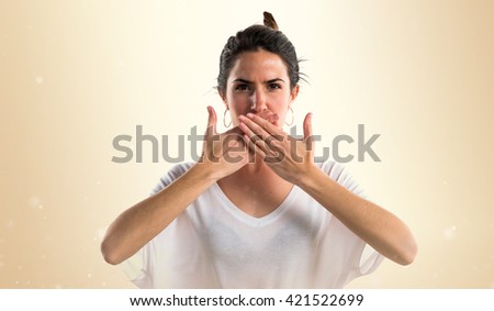 Young girl covering her mouth