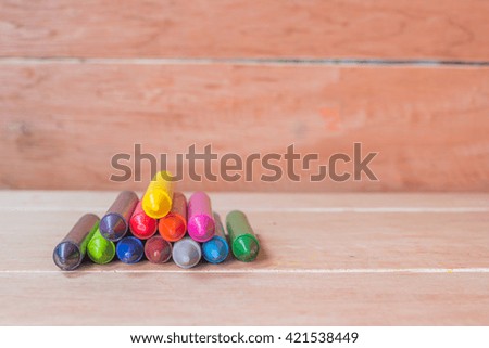 Colorful pastel crayons on wooden background