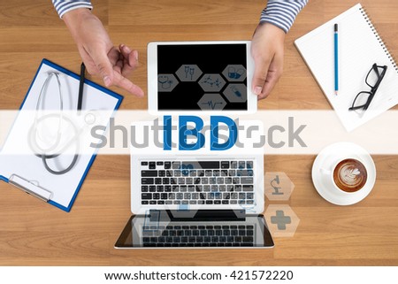 IBD - Inflammatory Bowel Disease. Medical Concept Doctor touch digital tablet, desktop with medical equipment on background, top view, coffee
