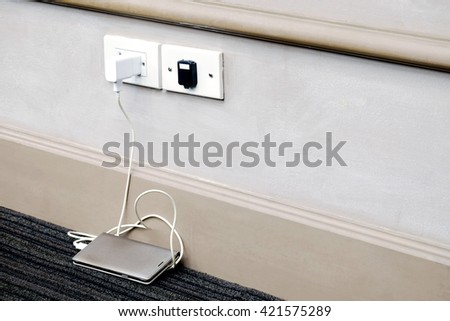smartphone charger which is inserted in socket with smartphone on carpet  
 Royalty-Free Stock Photo #421575289