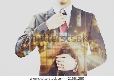 Double exposure of Businessman dissolved with blurry street lights in urban city