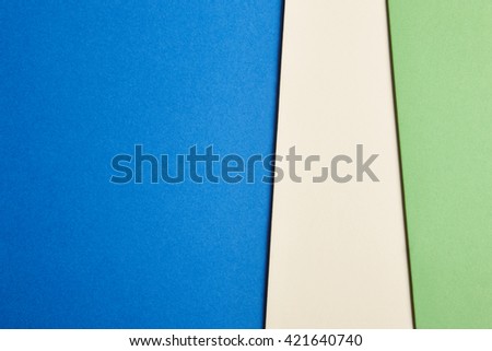 Colored cardboards background in blue beige green tone. Copy space. Horizontal