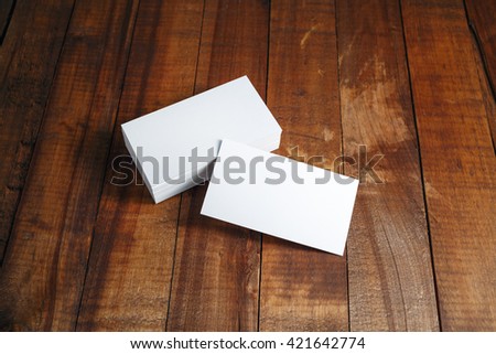 Blank business cards. Photo of blank business cards on vintage dark wooden background. Template for ID. For design presentations and portfolios.