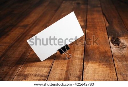 Blank business card. Photo of blank business card on vintage wooden background. Mock-up for branding identity. Blank template for ID.