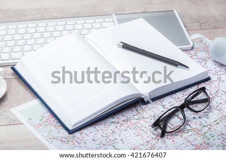 Diary notepad with accessories on table
