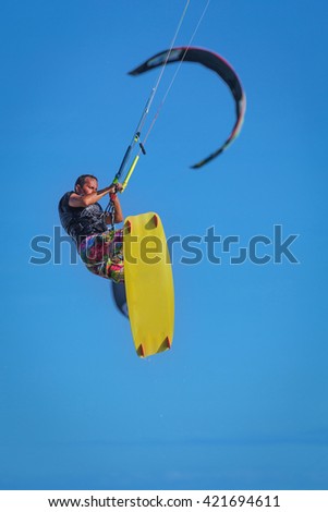 Athletic man jump on kite surf board on a sea waves