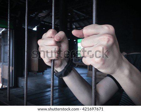 Man hand handle bars. Abstract photo concept of life imprisonment. Selective focus hand holding bars. Vintage tone.
