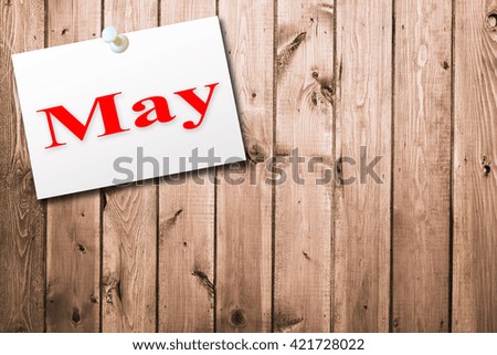 Text May on white short note paper. calendar on old wood background. Empty space for text.