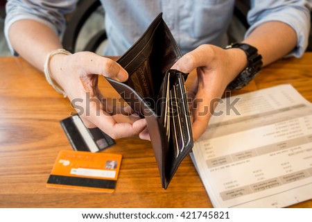 credit card debt - holding an empty wallet.
 Royalty-Free Stock Photo #421745821