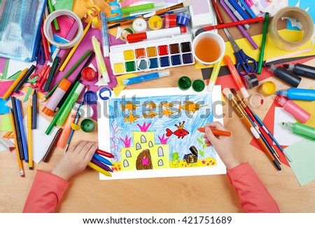castle under water with treasure, the king fish with crown, fairy tale, child drawing, top view hands with pencil painting picture on paper, artwork workplace
