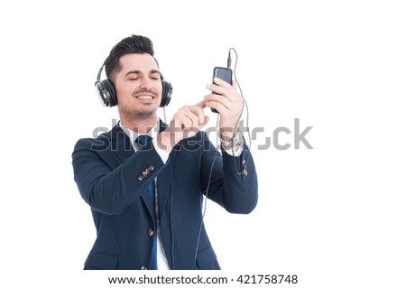 Cheerful salesman listening music and working on cellphone as modern technology concept isolated on white background