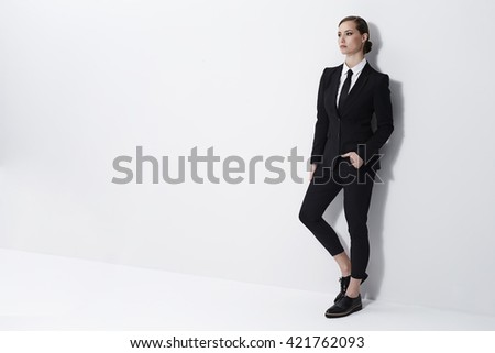 Seriously cool businesswoman in white studio