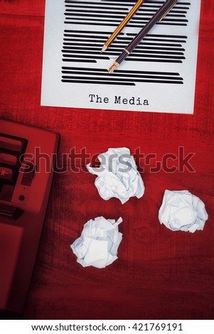 The media message against view of an old typewriter and paper