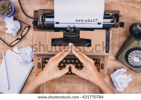 www.what? message on a white background against above view of typewriter and old phone