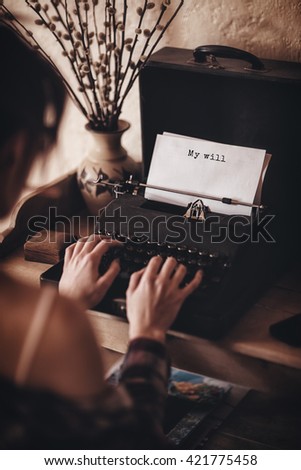 My will message on a white background against rear view of a woman is using a writing machine