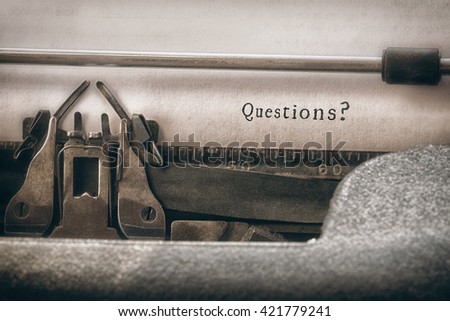 Questions? message against close-up of typewriter