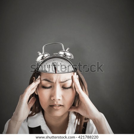 Nervous businesswoman holding her head against grey