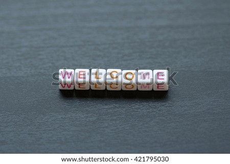 Welcome cube shape on wooden backgrounds