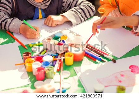 children draw with parents paint beautiful pictures, children's creativity
 Royalty-Free Stock Photo #421800571