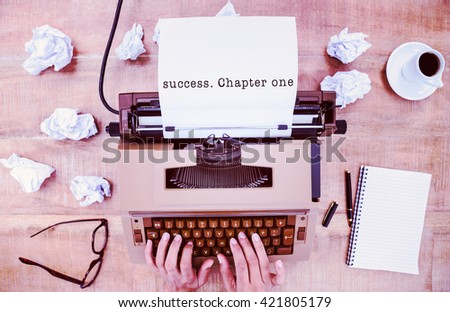 Success. Chapter one message on a white background against above view of old typewriter