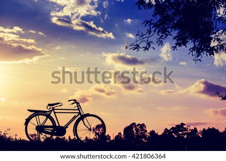 beautiful landscape image with Silhouette Bicycle at sunset