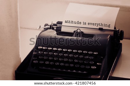 Attitude is everything message on a white background against typewriter on a table