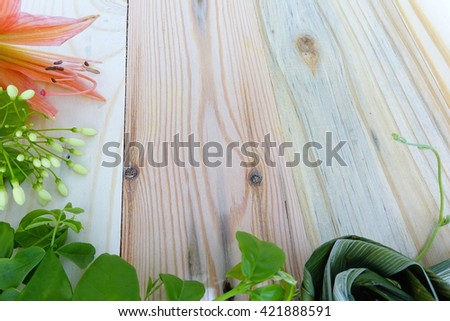 Flowers and fresh green leaf on wooden background.Festive greeting card:Close up,select focus with shallow depth of field:ideal use for background.