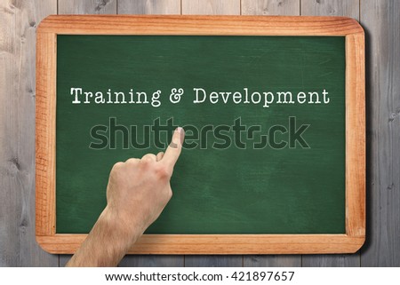 Hand pointing against composite image of chalkboard