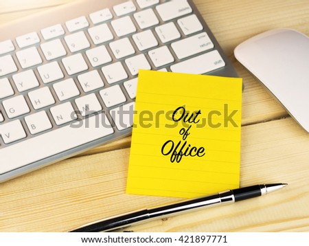 Out of office on sticky note on work desk Royalty-Free Stock Photo #421897771