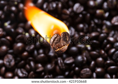 Coffee bean in flames Background brown dark roasted coffee beans. Roasting coffee concept