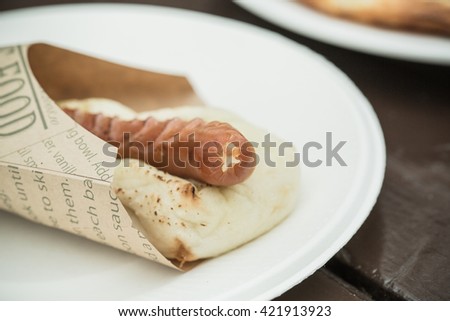 Grilled Bratwurst with mustard on bun. Isolated.