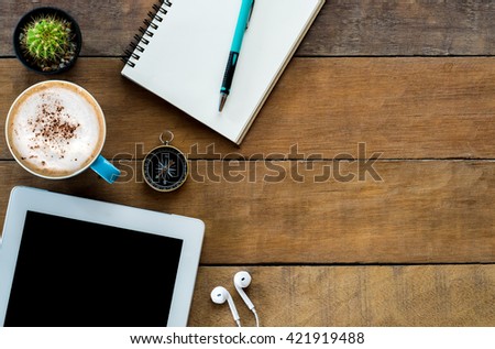 Office stuff with blank screen tablet, coffee cup ,pencil and leather notebook.Top view with copy space.Office supplies and gadgets on desk table.Working desk table concept.Flat lay images.