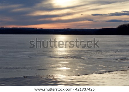 Photo of a beautiful sunset on the icy lake