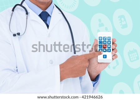 Midsection of male doctor pointing on mobile phone against medical icons