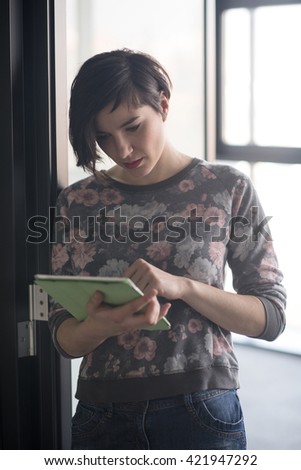 yonug businesswoman in casual hipster clothes working on tablet computer at modern startup business office interior