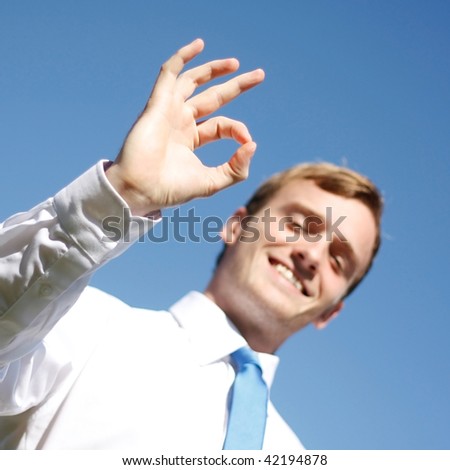 A business man displaying OK signs