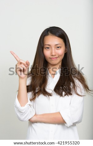 Teenager girl with idea pointing finger up