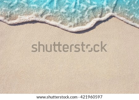 Soft Wave Of Blue Ocean On Sandy Beach. Background. Selective focus. Royalty-Free Stock Photo #421960597