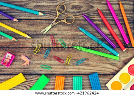 Stationery objects. School supplies on old wood background. Toned image. 