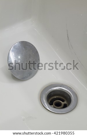 stainless steel kitchen sink drain. Bathroom interior with white sink and silver faucet