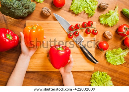 Top View Picture of Hands on tableboard with vegetables holding 